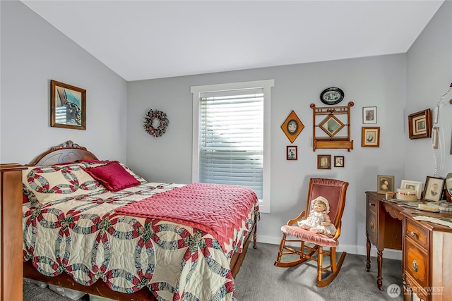 bedroom featuring lofted ceiling and baseboards