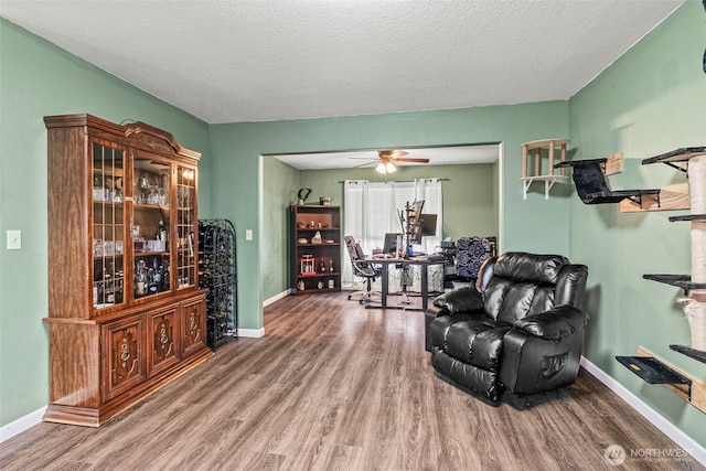 living room with baseboards and wood finished floors