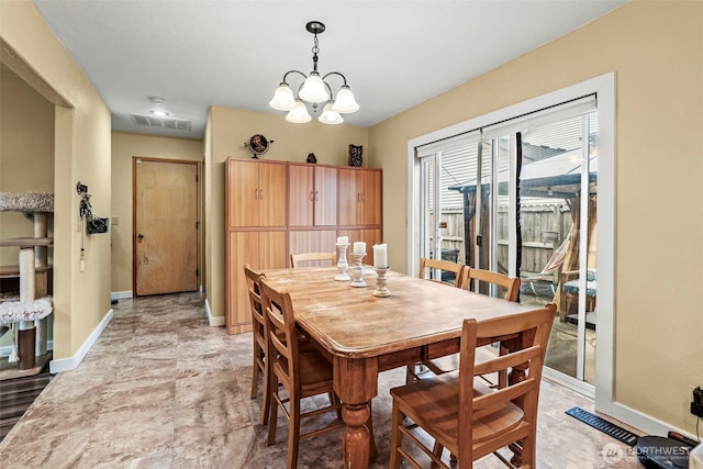 dining room with a chandelier, visible vents, and baseboards