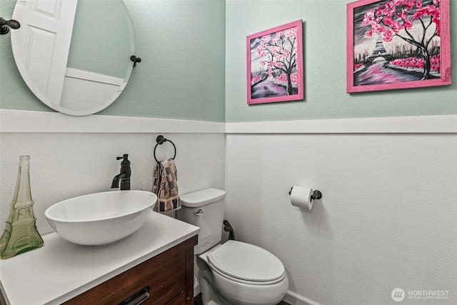 bathroom with toilet and vanity