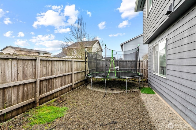 view of yard featuring a fenced backyard and a trampoline