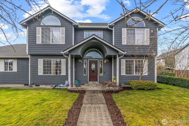 view of front of property with a front lawn and fence