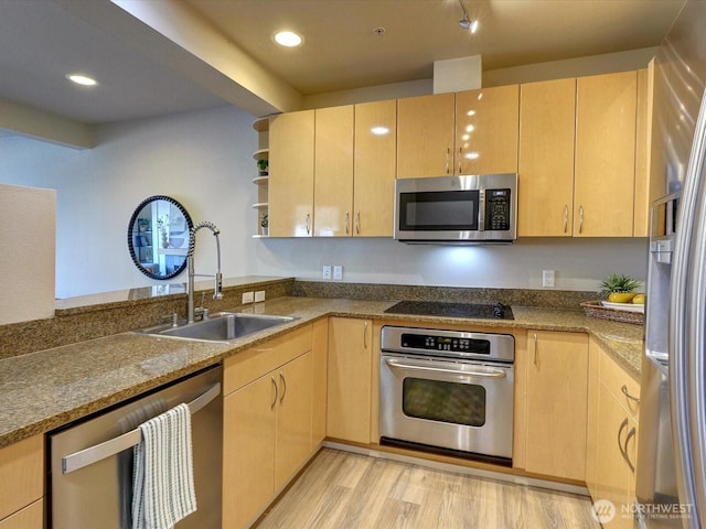 kitchen featuring appliances with stainless steel finishes, light brown cabinets, a sink, and open shelves