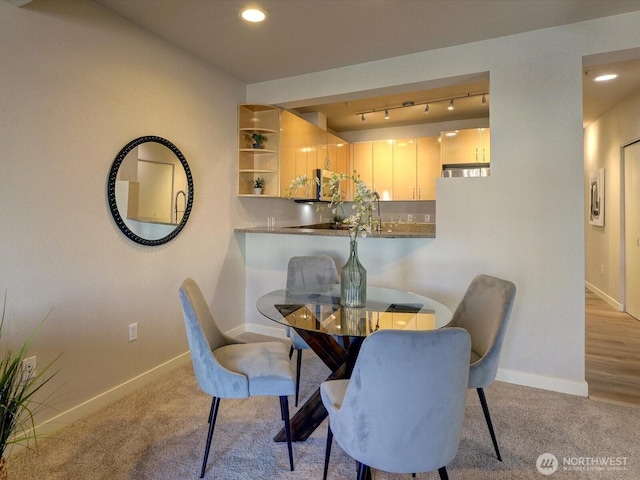 carpeted dining space with track lighting, recessed lighting, and baseboards