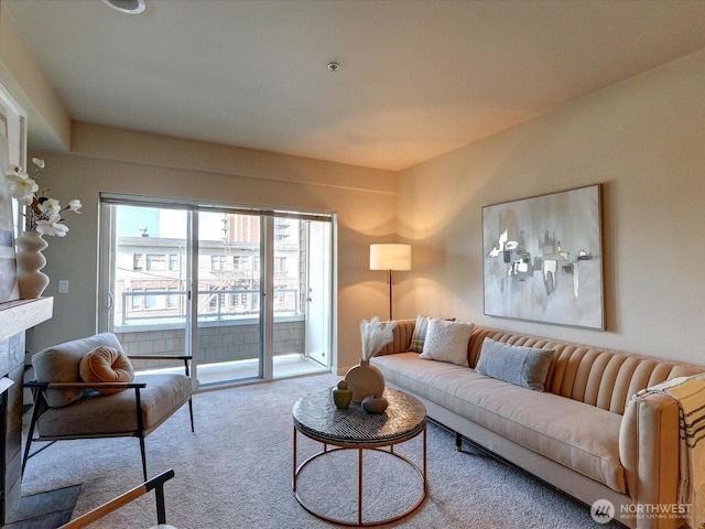 living area featuring carpet and a fireplace