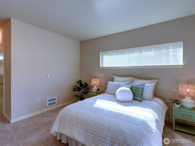 carpeted bedroom with visible vents and baseboards