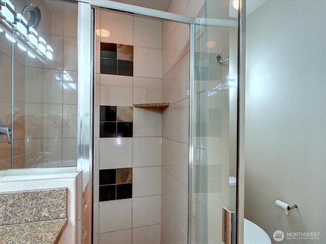 bathroom with a stall shower and toilet