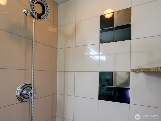 interior details featuring tiled shower