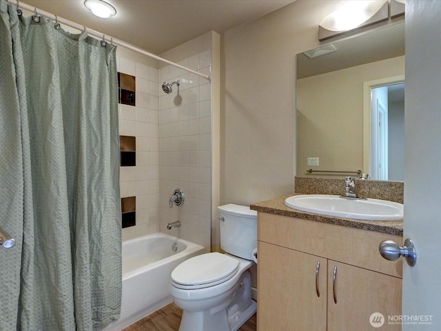 bathroom with toilet, wood finished floors, shower / tub combo with curtain, and vanity