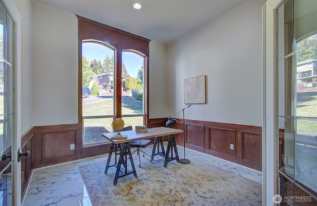 office area featuring a healthy amount of sunlight, crown molding, and wainscoting