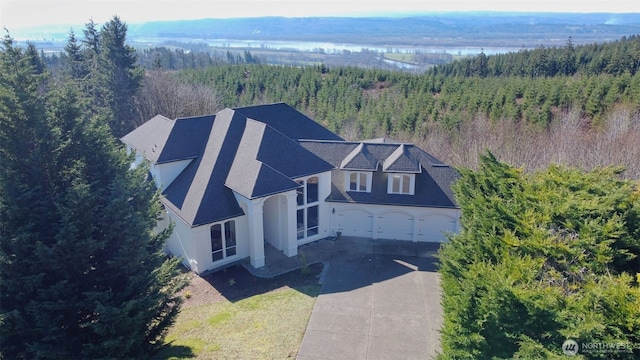 drone / aerial view featuring a forest view