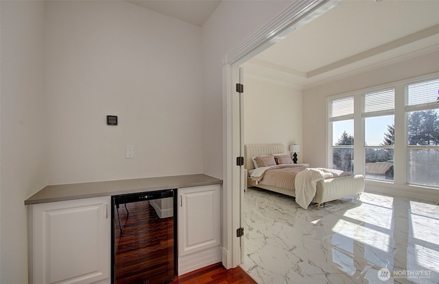 bedroom featuring beverage cooler and a dry bar