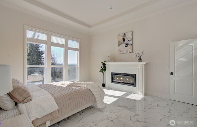 bedroom with marble finish floor, baseboards, crown molding, and a glass covered fireplace