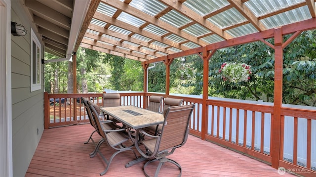 wooden deck featuring a pergola and outdoor dining space