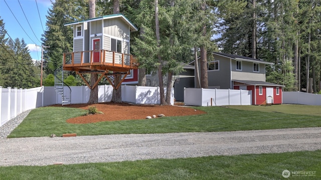 contemporary house featuring a garage, board and batten siding, a front yard, and a fenced backyard