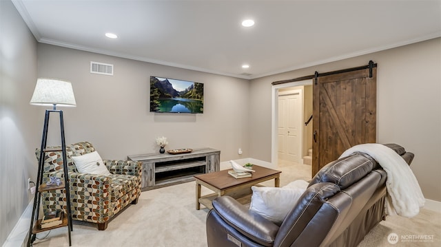 living area featuring ornamental molding, a barn door, visible vents, and light colored carpet