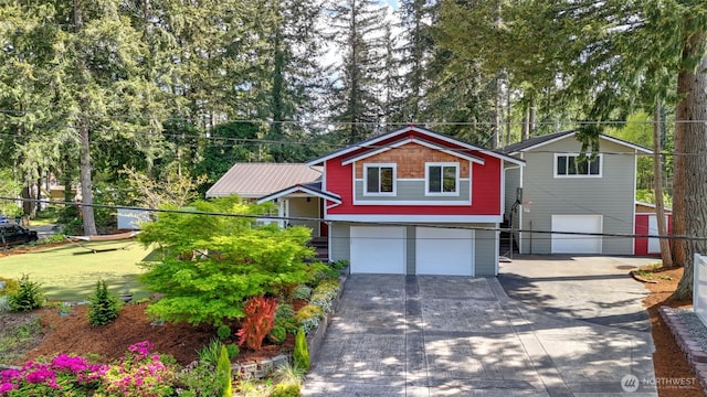 view of front of property with a garage, fence, and driveway