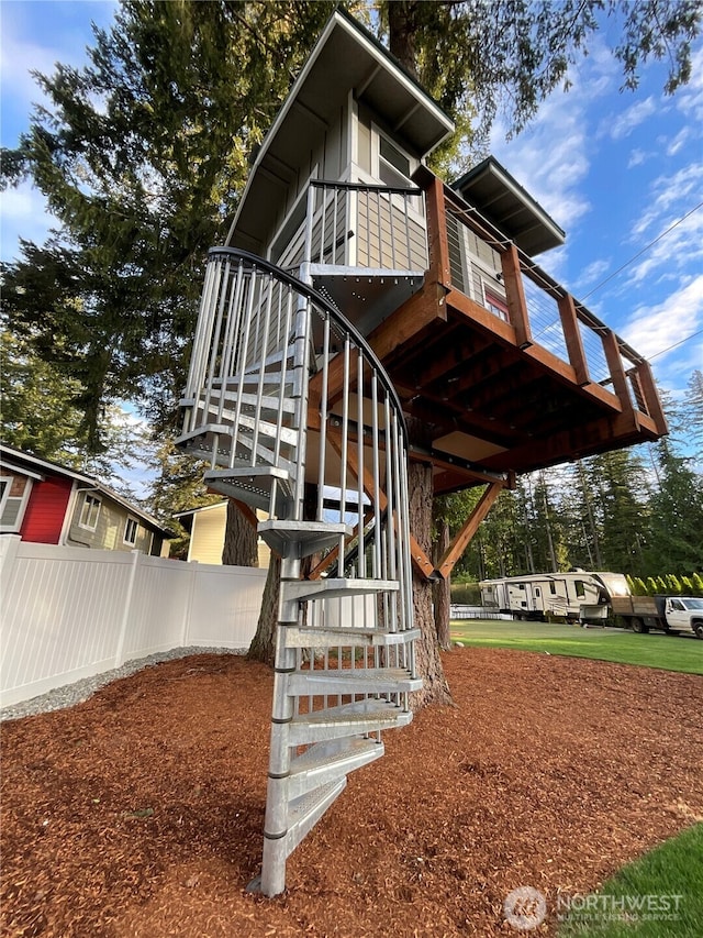 view of side of home featuring stairway