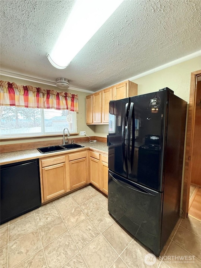 kitchen featuring light brown cabinetry, a sink, black appliances, light countertops, and a textured ceiling