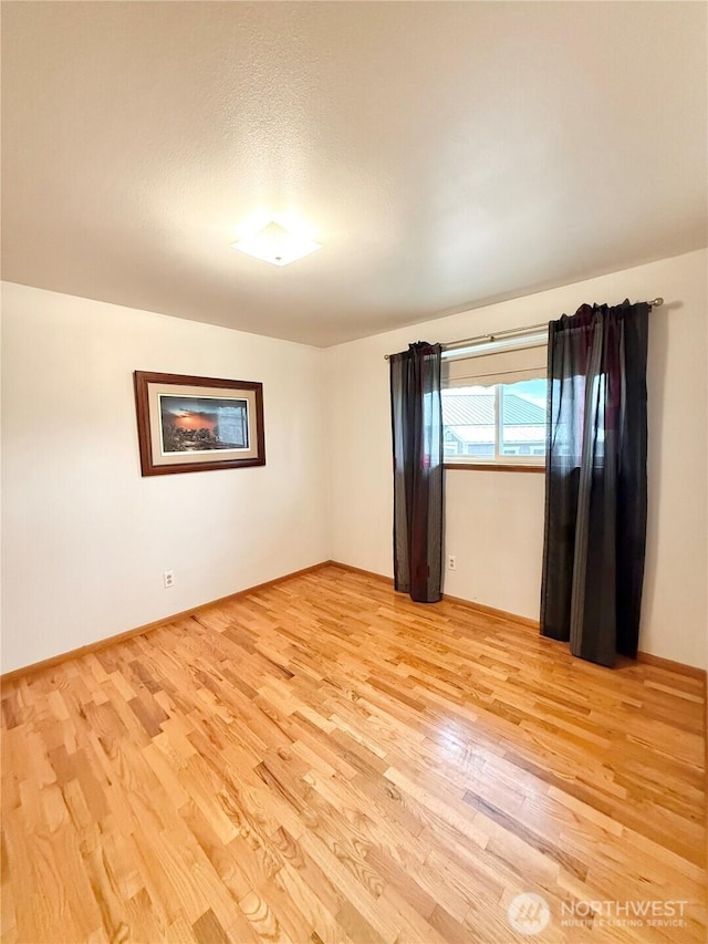 unfurnished room with light wood-type flooring