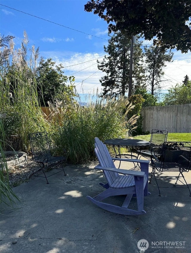 view of patio / terrace featuring fence