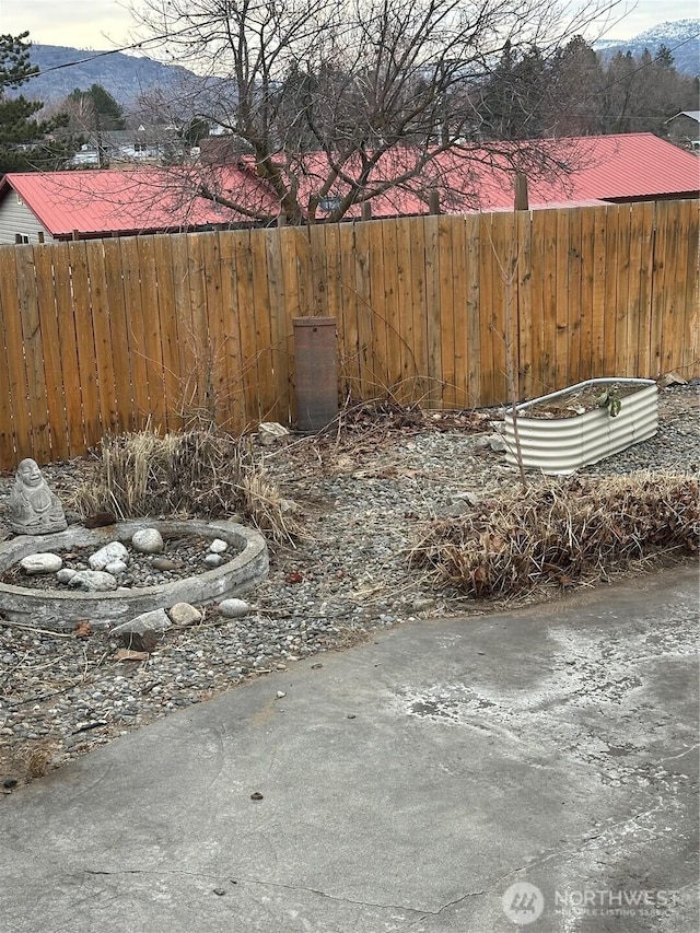 view of yard featuring a mountain view and fence