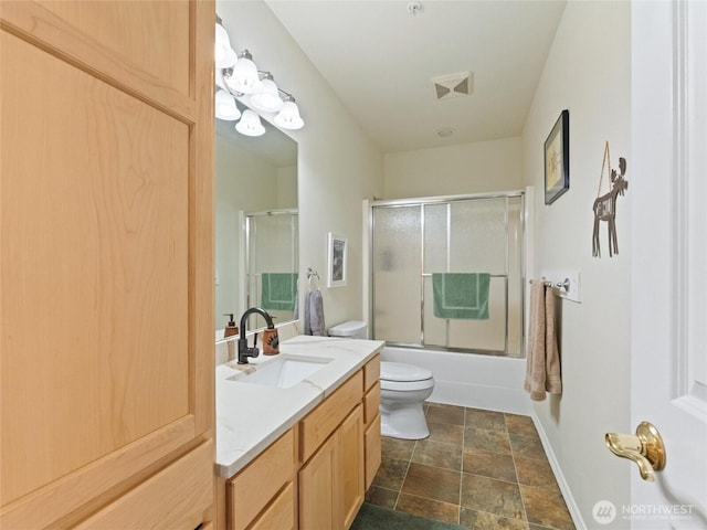 full bathroom with toilet, visible vents, vanity, baseboards, and combined bath / shower with glass door