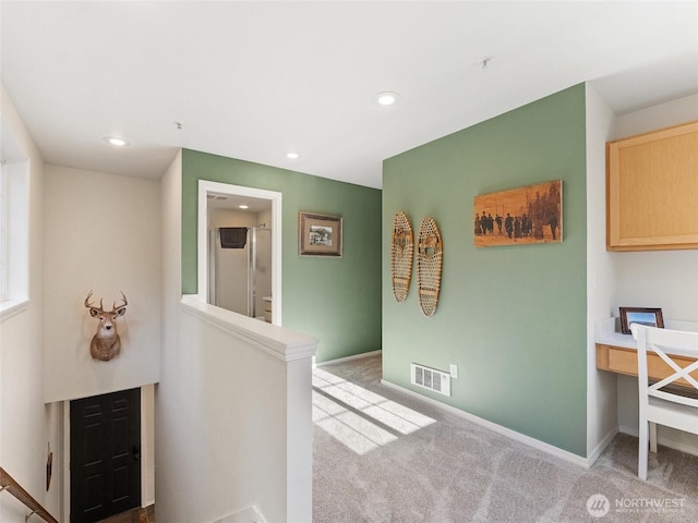 hall with baseboards, visible vents, carpet flooring, an upstairs landing, and recessed lighting