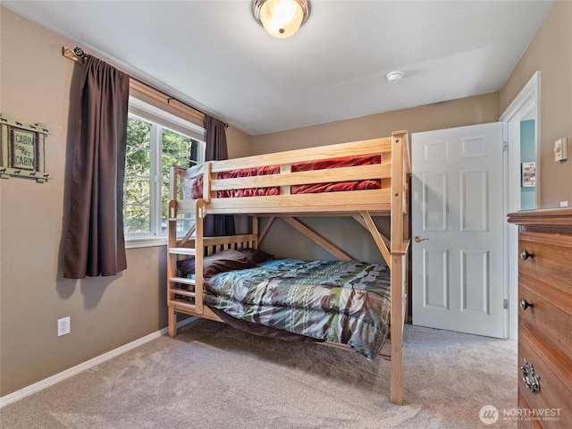 bedroom with carpet floors and baseboards