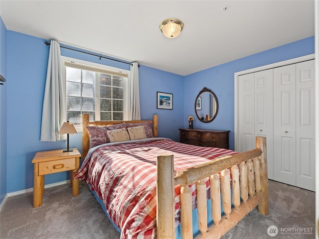 bedroom with carpet floors, baseboards, and a closet