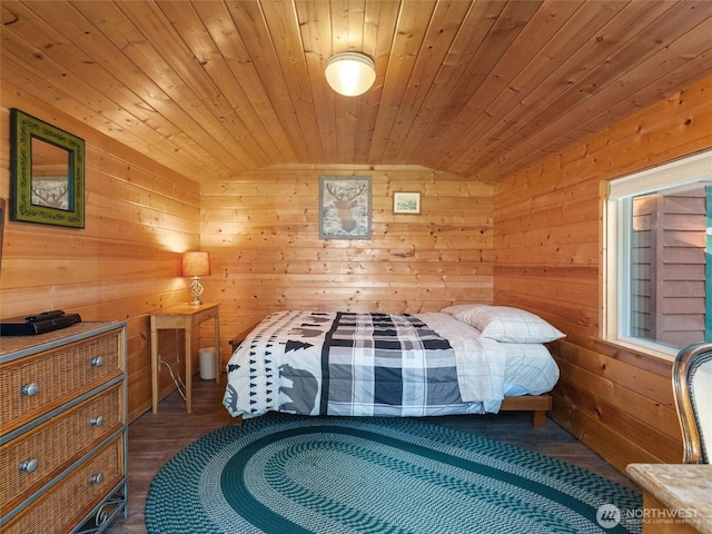 bedroom with lofted ceiling, wood ceiling, wood walls, and wood finished floors