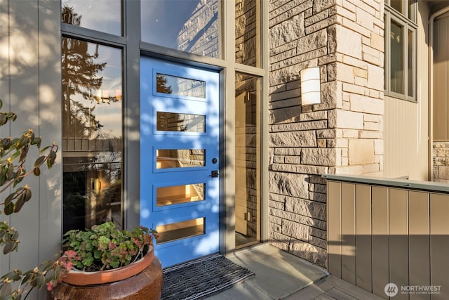 property entrance with stone siding