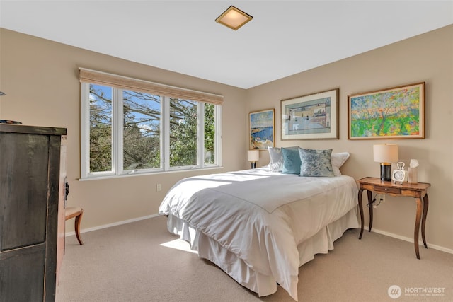 bedroom with light carpet and baseboards