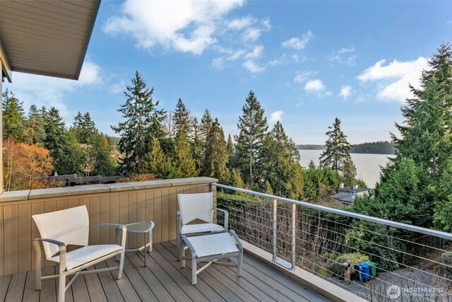 deck featuring a water view and a view of trees