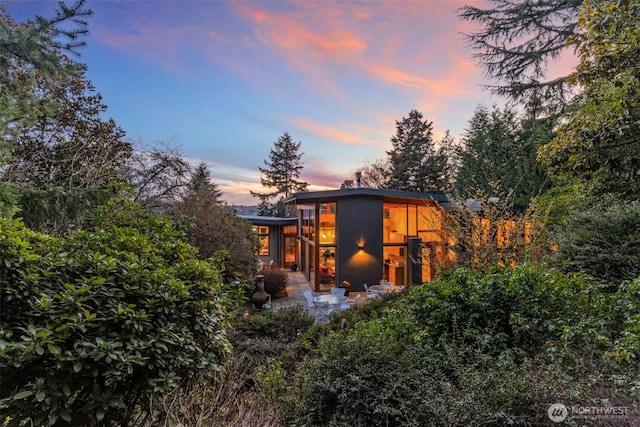 view of back of house at dusk