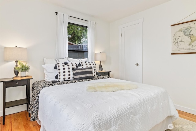 bedroom with wood finished floors and baseboards