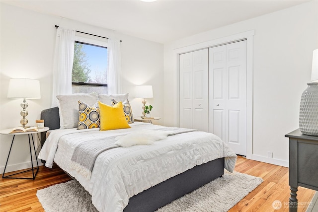 bedroom featuring a closet, baseboards, and wood finished floors