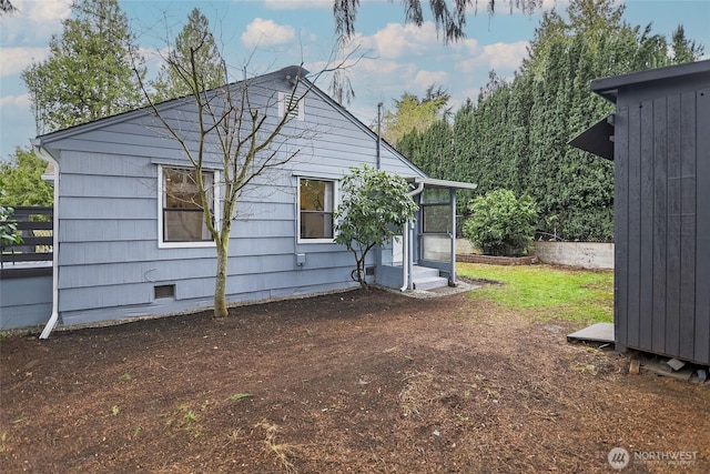 back of property featuring crawl space and entry steps