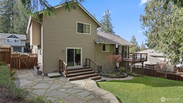 back of house with a patio area, a gate, fence, and a lawn