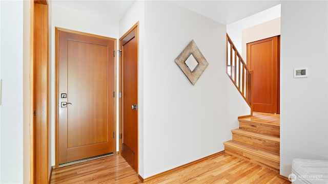 foyer with stairway and light wood-style floors