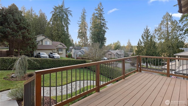 wooden terrace featuring a residential view and a lawn