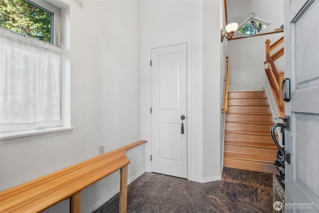 entryway featuring stairway and baseboards