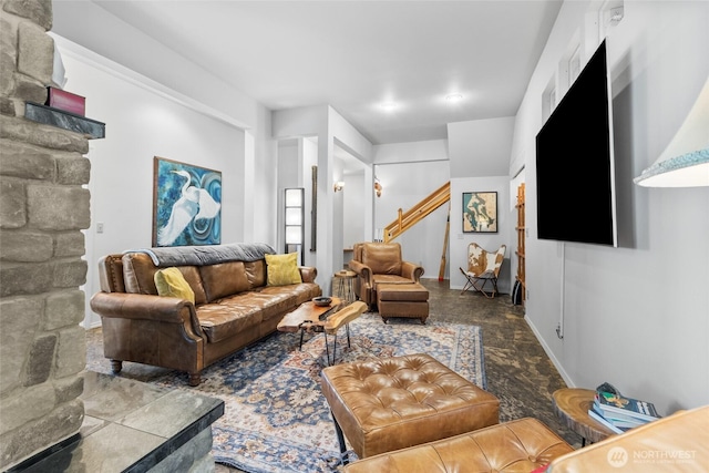 living room featuring stone finish floor and baseboards