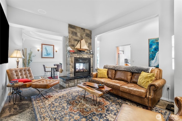 living area with a fireplace and baseboards