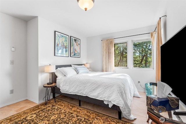 bedroom featuring baseboards and light tile patterned flooring