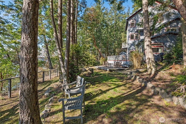 view of yard featuring a deck and fence