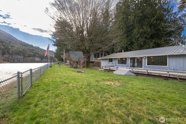 view of yard featuring a deck, an outdoor fire pit, and a fenced backyard