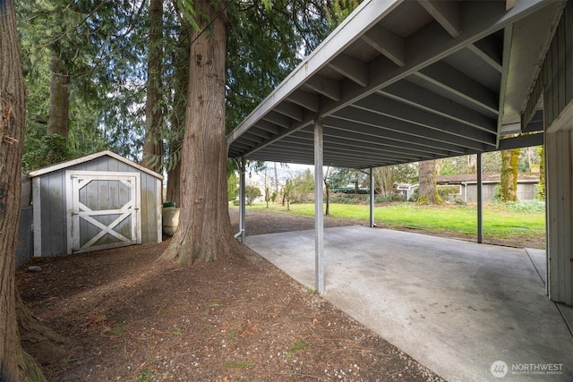 view of car parking featuring a carport, a storage unit, and driveway