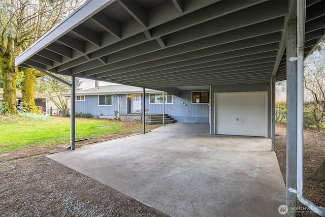 view of patio featuring a carport, concrete driveway, and a garage