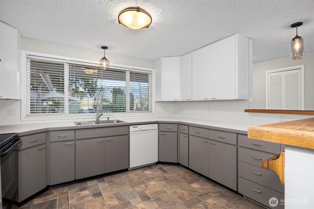 kitchen with dishwasher, black / electric stove, a sink, and gray cabinetry